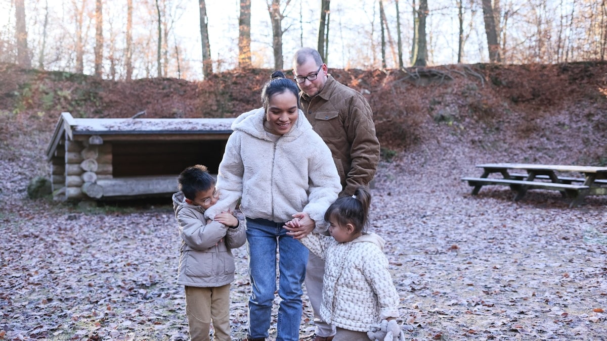 Family walking together in a forest clearing
